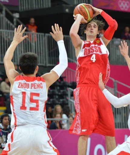 Chinese forward Zhou Peng vies Russian guard Alexey Shved (right) during the men's preliminary round group B basketball match at the basketball arena in London. Russia's Andrei Kirilenko and Shved, future NBA teammates for the Minnesota Timberwolves, powered a veteran Russian side over China 73-54 to stay unbeaten in Olympic round-robin play