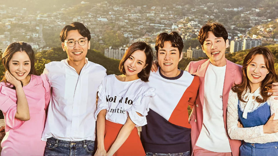 the contestants of the korean dating show 'heart signal,' standing in front of the sunny seoul cityscape