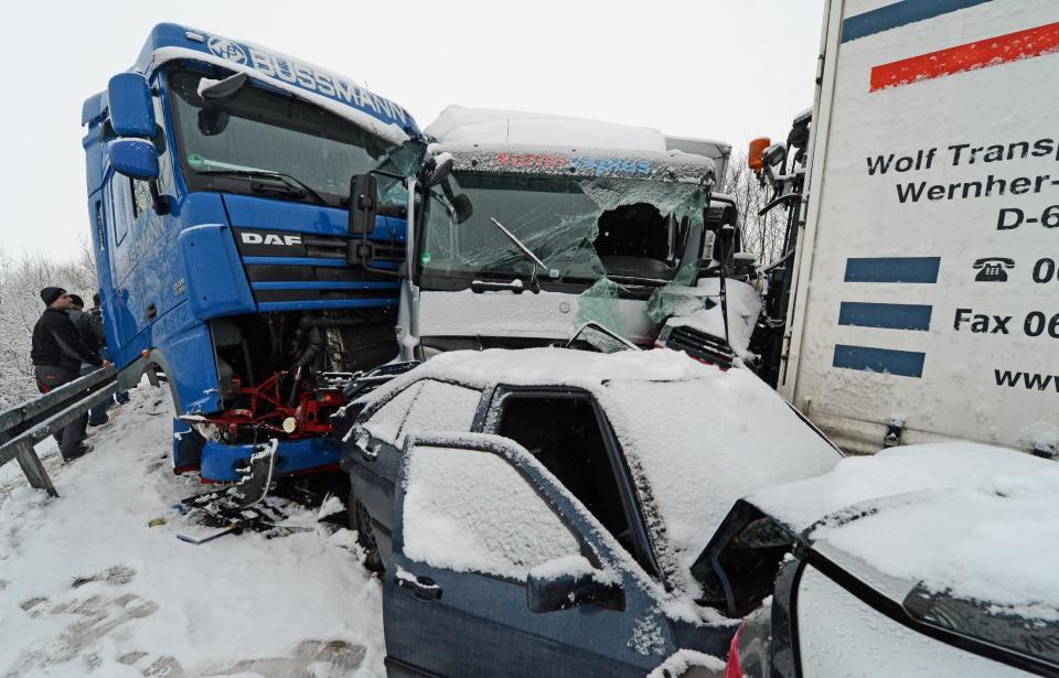 Wrecked cars and trucks are piled up after a mass-crash on highway A45 near Woelfersheim, central Germany, Tuesday March 12, 2013.   (AP Photo/dpa, Boris Roessler)