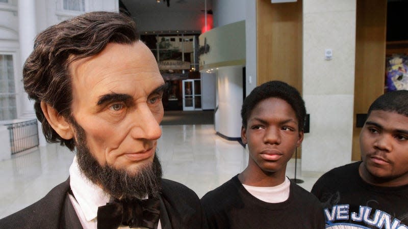 High School students examine a life size Abraham Lincoln replica at the Lincoln Presidential Library in Springfield, IL.