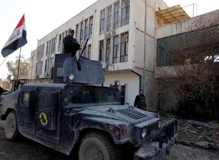 A member of Iraqi Special Operations Forces (ISOF) stands in a military vehicle at the University of Mosul during a battle with Islamic State militants, in Mosul, Iraq, January 14, 2017. REUTERS/Ahmed Saad