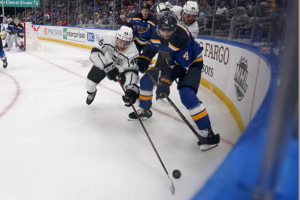 Los Angeles Kings' Blake Lizotte (46) and St. Louis Blues' Nick Leddy (4) battle for a loose puck along the boards during the third period of an NHL hockey game Monday, Oct. 31, 2022, in St. Louis. (AP Photo/Jeff Roberson)