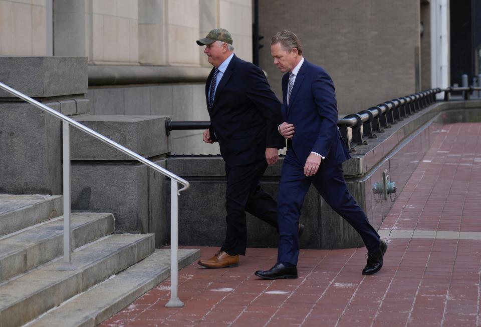 Former Ohio House Speaker Larry Householder, left, heads into Potter Stewart U.S. Courthouse in downtown Cincinnati Thursday.