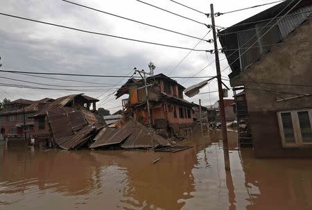 A house destroyed by flood waters is seen in Srinagar September 12, 2014. REUTERS/Adnan Abidi