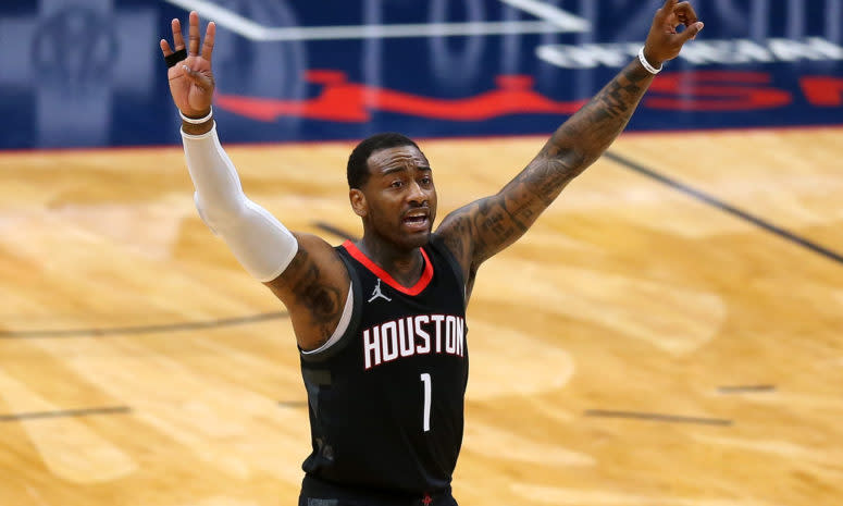 John Wall #1 of the Houston Rockets puts both arms up in the air