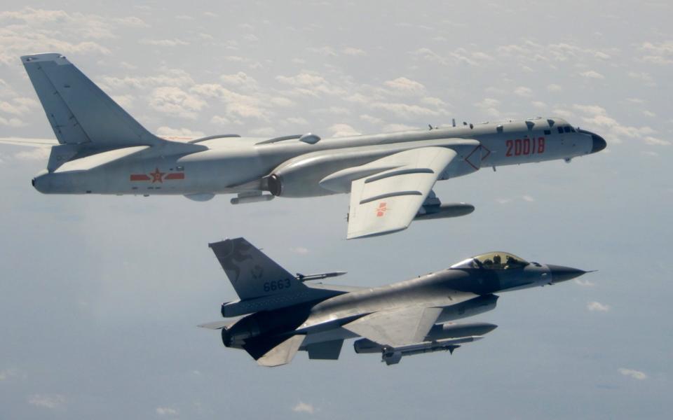 A Taiwanese F-16 flies on the flank of a PLAAF H-6 bomber - AP