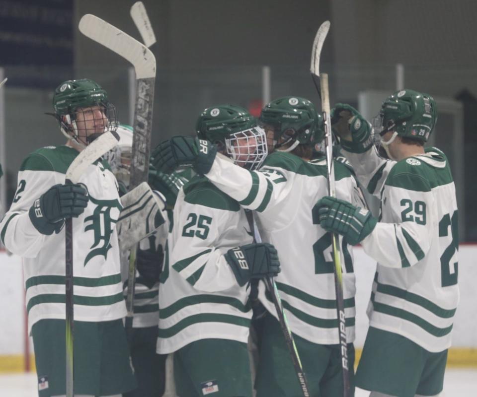 The Dover High School boys hockey team celebrating a 7-0 win over Timberlane on Wednesday night at Dover Ice Arena.