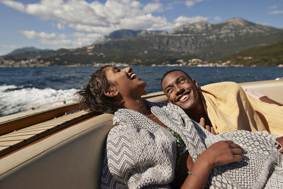 Young man and woman laughing in speedboat (Klaus Vedfelt / Getty Images)