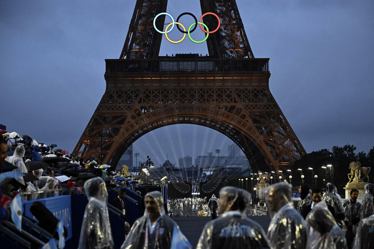 The Eiffel Tower and Olympic Rings are illuminated at the Trocadero during the opening ceremony for the 2024 Summer Olympics in Paris, France, Friday, July 26, 2024. (Loic Venance/Pool Photo via AP)