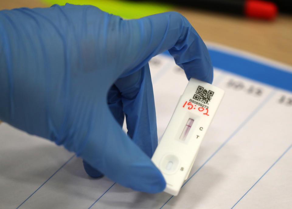 People carry out asymptomatic testing using lateral flow antigen at a test centre at Edinburgh University ahead of students being allowed to travel home for the Christmas holidays.