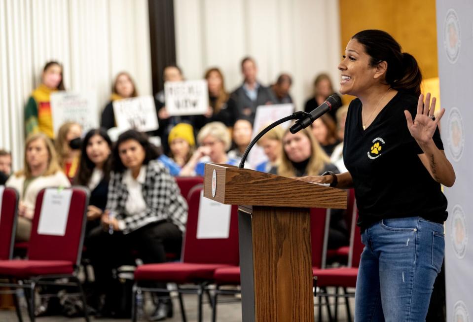 A concerned parent, Jessica Nettles, speaks in front of a crowd