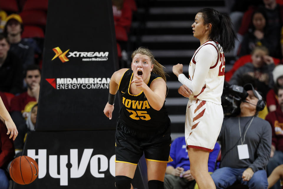 Iowa forward Monika Czinano reacts in front of Iowa State forward Kristin Scott, right, after making a basket during the first half of an NCAA college basketball game, Wednesday, Dec. 11, 2019, in Ames, Iowa. (AP Photo/Charlie Neibergall)