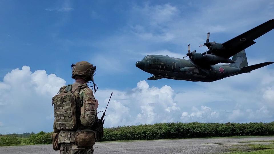 Maj. Michael Bakke, with the 621st Mobility Support Operations Squadron, Joint Base McGuire-Dix-Lakehurst, N.J., prepares as a Japanese C-130 Hercules lands at Baker Landing Zone on Tinian, U.S. Commonwealth of the Northern Marianas, July 12 during Mobility Guardian. (Lt. Col. Daniel Pool/Air Force)