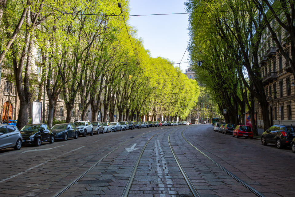 Parked cars line a street devoid of traffic in Milan, Italy in early April. Milan plans to open 22 miles of street to new cycle paths in May and June. (Credit: Francesca Volpi/Bloomberg)