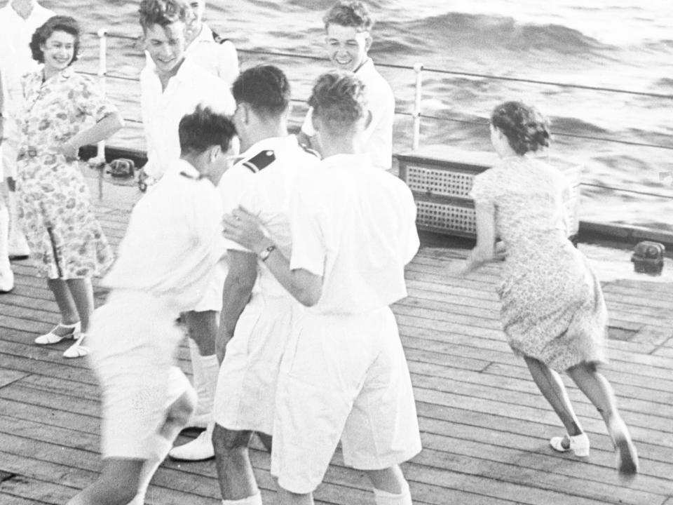 princess margaret and princess elizabeth playing with shipmen aboard the battleship on their way to South Africa