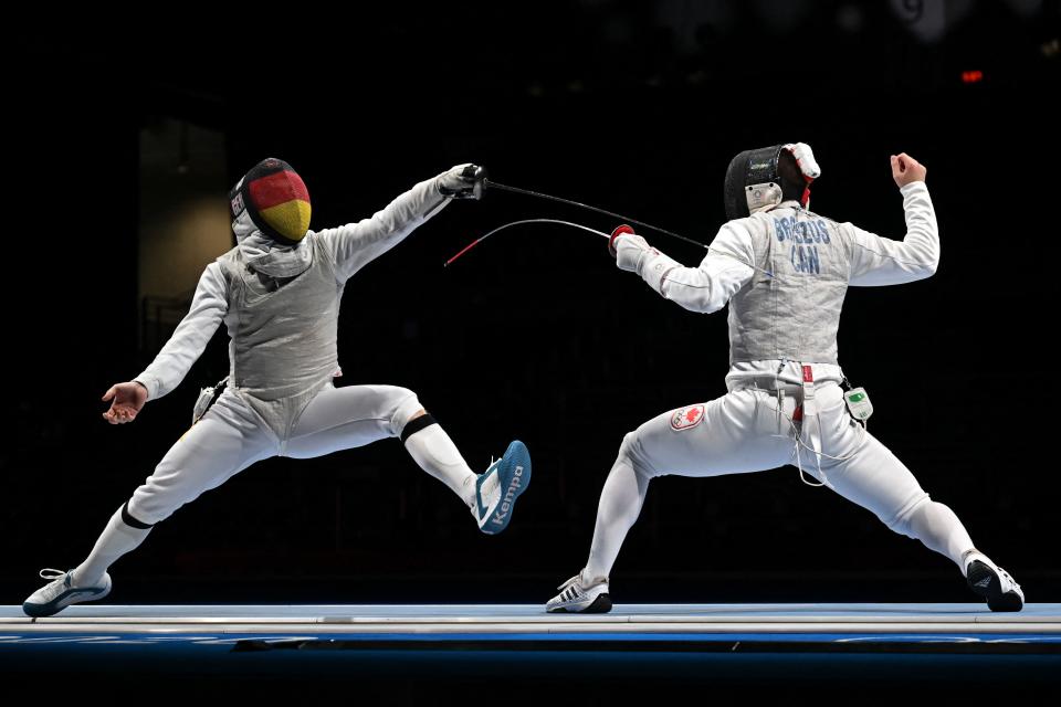 <p>Germany's Andre Sanita (L) compete against Canada's Blake Broszus in the mens team foil qualifying bout during the Tokyo 2020 Olympic Games at the Makuhari Messe Hall in Chiba City, Chiba Prefecture, Japan, on August 1, 2021. (Photo by Fabrice COFFRINI / AFP)</p> 