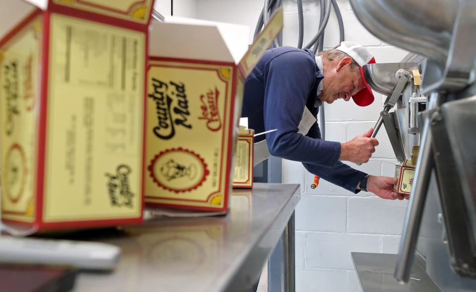 Country Maid co-owner Don Torma fills boxes of pistachio ice cream in Richfield.