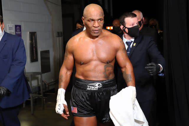 <p>Joe Scarnici/Getty</p> Mike Tyson exits the ring in 2020