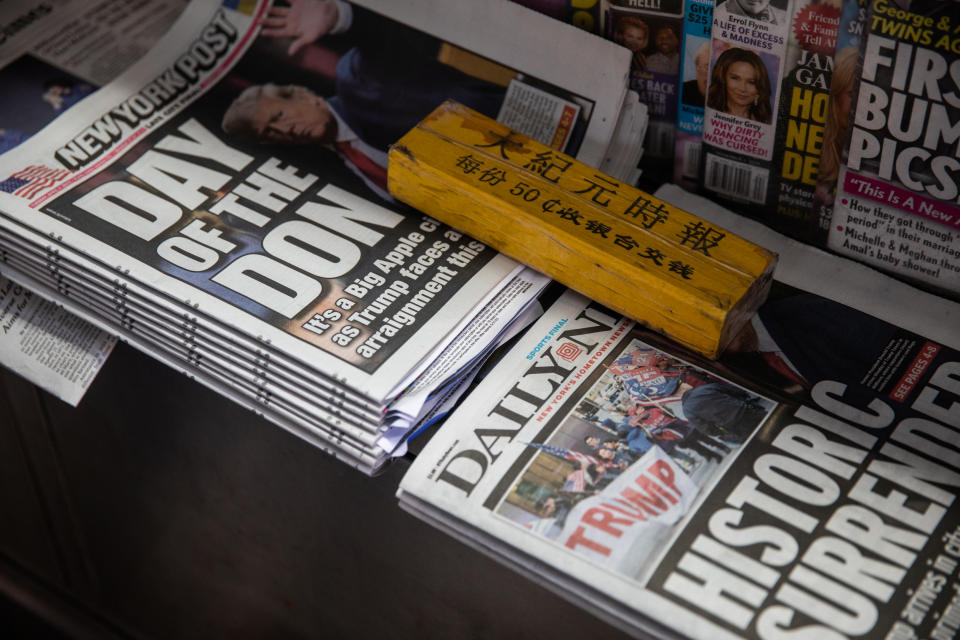 Newspapers highlighting former President Donald Trump's arrest and arraignment are among the offerings at Abul Kalam Azad's newstand near New York Criminal Court on April 4, 2023. (Julius Constantine Motal / NBC News)