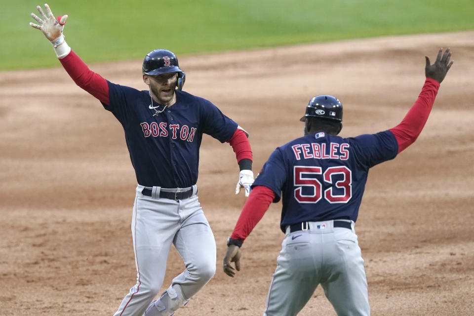 Boston Red Sox's Trevor Story, left, celebrates his three-run home run off Chicago White Sox starting pitcher Dylan Cease with third base coach Carlos Febles during the first inning of a baseball game Tuesday, May 24, 2022, in Chicago. (AP Photo/Charles Rex Arbogast)