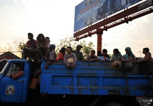 Labourers are seen standing in a truck as they travel back from work near Mandalay in central Myanmar, on March 2. The new government, which took power last year ending five decades of military rule, has signed peace deals with rebel groups in an effort to end a civil war that has gripped parts of Myanmar since independence in 1948