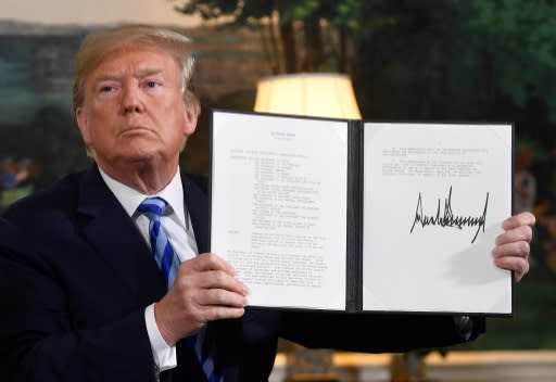 President Donald Trump signs a document reinstating sanctions against Iran, at the White House in Washington, DC, on May 8, 2018