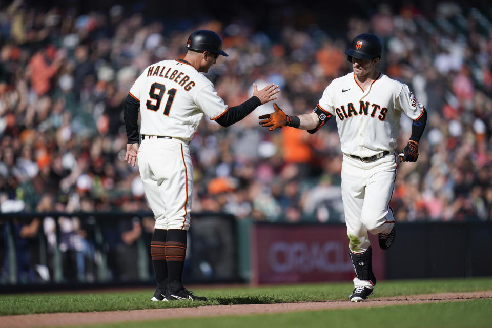 San Francisco Giants' Mike Yastrzemski, right, celebrates with third base coach Mark Hallberg (91) after hitting a solo home run against the Arizona Diamondbacks during the eighth inning of a baseball game in San Francisco, Saturday, Oct. 1, 2022. (AP Photo/Godofredo A. Vásquez)