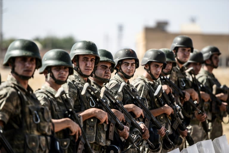 Turkish soldiers stand guar near the Turkey-Syrian border post in Sanliurfa, on September 4, 2015