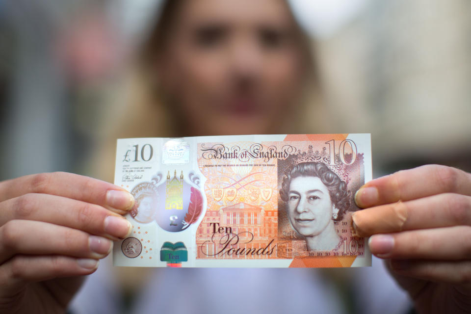 A woman holding a new ten pound note. Photo: Aaron Chown/PA Archive/PA Images