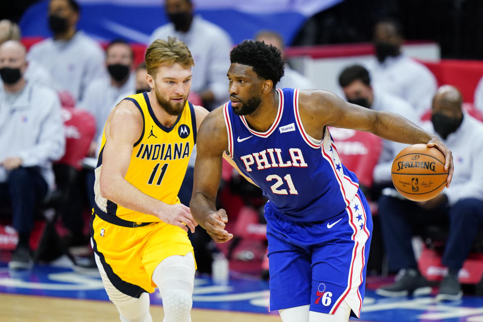 Philadelphia 76ers' Joel Embiid (21) dribbles against Indiana Pacers' Domantas Sabonis (11) during the first half of an NBA basketball game, Monday, March 1, 2021, in Philadelphia. (AP Photo/Matt Slocum)