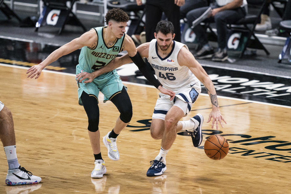Charlotte Hornets guard LaMelo Ball (2) defends against Memphis Grizzlies guard John Konchar (46) during the first half of an NBA basketball game in Charlotte, N.C., Friday, Jan. 1, 2021. (AP Photo/Jacob Kupferman)
