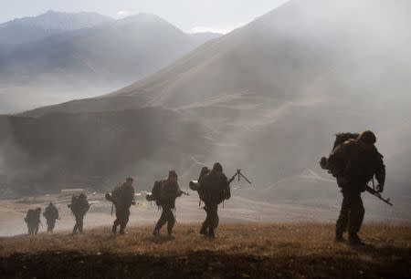 Russian servicemen take part in an exercise to test a new mobile cable lift on a military training ground, about 15 km (9 miles) south of Vladikavkaz, in the Republic of North Ossetia November 23, 2012. The cable lift is capable of carrying a load up to 500 kg (1102 lbs) for distances up to 3 km (2 miles), military officials said. REUTERS/Kazbek Basayev