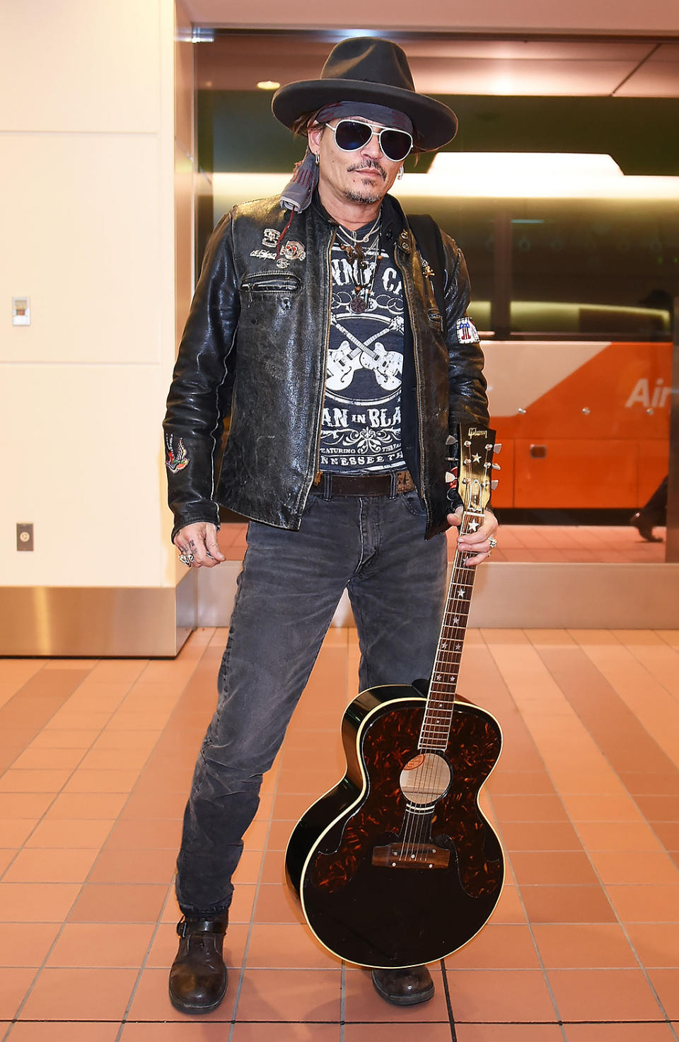 <p>Depp rock ‘n’ rolled into Tokyo’s Haneda Airport looking cool. (He left the pirate gear at home.) (Photo: Jun Sato/GC Images) </p>