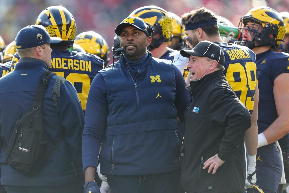 Michigan interim head coach Sherrone Moore watches a replay during the first half against Ohio State at Michigan Stadium in Ann Arbor on Saturday, Nov. 25, 2023.