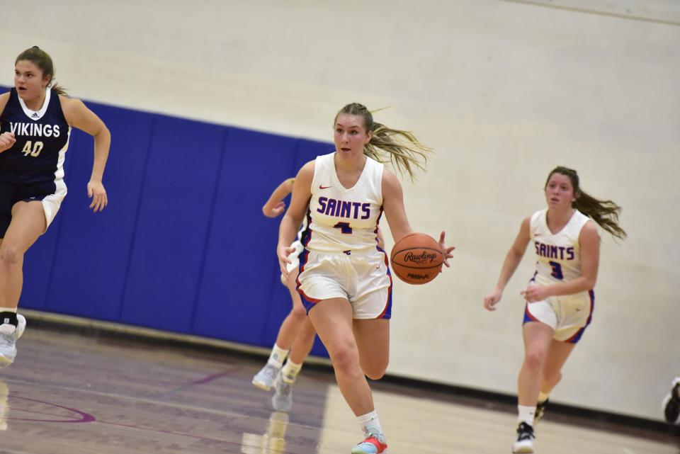 St. Clair's Erin Seros dribbles down the court during the Saints' 45-43 win over Marysville at St. Clair High School on Tuesday, Dec. 6, 2022.