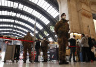 Police officers and soldiers check passengers leaving from Milan main train station, Italy, Monday, March 9, 2020. Italy took a page from China's playbook Sunday, attempting to lock down 16 million people — more than a quarter of its population — for nearly a month to halt the relentless march of the new coronavirus across Europe. Italian Premier Giuseppe Conte signed a quarantine decree early Sunday for the country's prosperous north. Areas under lockdown include Milan, Italy's financial hub and the main city in Lombardy, and Venice, the main city in the neighboring Veneto region. (AP Photo/Antonio Calanni)