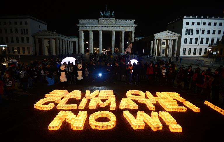Candles in paper bags are placed to form the lettering "Save our climate, Now" in Berlin during the global climate change awareness campaign "Earth Hour" on March 28, 2015