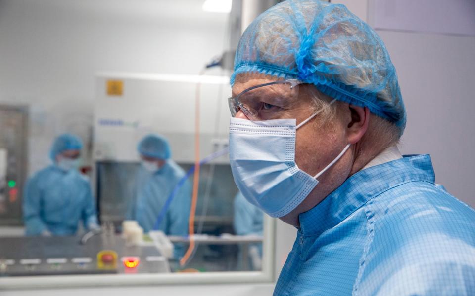 Boris Johnson at a viewing window where technicians are manufacturing the AstraZeneca Covid-19 vaccine - Heathcliff O'Malley