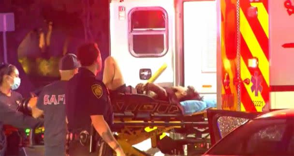 PHOTO: An ambulance removes Erik Cantu from the shooting scene as emergency personnel respond to the scene of a police officer shooting a teenager outside of McDonalds in San Antonio, Texas, Oct. 2, 2022. (KSAT)