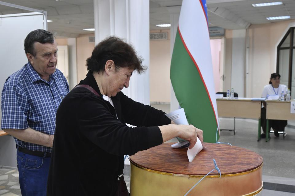 People vote at a polling station during a referendum in Tashkent, Uzbekistan, Sunday, April 30, 2023. Voters in Uzbekistan are casting ballots in a referendum on a revised constitution that promises human rights reforms. But the reforms being voted on Sunday also would allow the country's president to stay in office until 2040. (AP Photo)