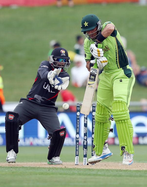 Pakistan's Misbah-ul-Haq (R) plays a shot next to the UAE's Swapnil Patil during their Cricket World Cup match in Napier on March 4, 2015