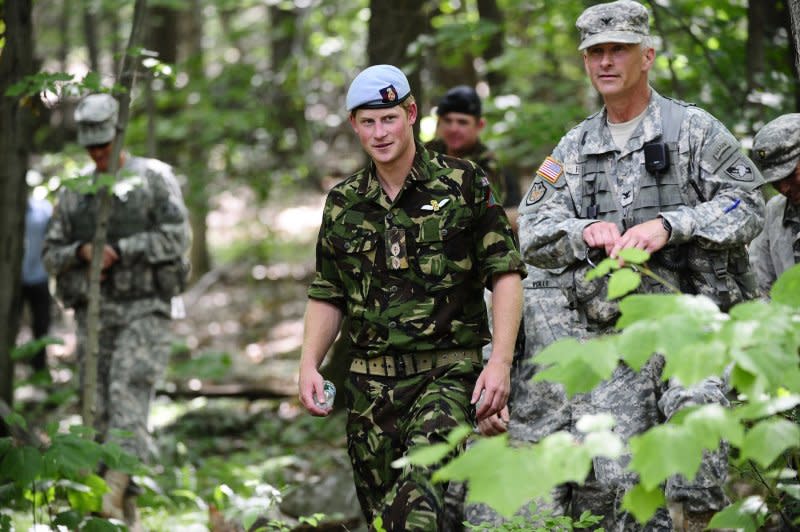 Britain's Prince Harry walks out of the woods after observing a combat simulation during a visit at the U.S. Military Academy in West Point, New York, on June 25, 2010. On February 28, 2008, Prince Harry was pulled from the front lines in Afghanistan immediately after word got out that he was on army duty. He had spent 10 weeks in the war zone. File Photo by Emmanuel Dunand/Pool