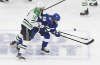 Dallas Stars' Jason Dickinson (18) and Tampa Bay Lightning's Nikita Kucherov (86) battle for the puck during first-period NHL Stanley Cup finals hockey action in Edmonton, Alberta, Saturday, Sept. 19, 2020. (Jason Franson/The Canadian Press via AP)