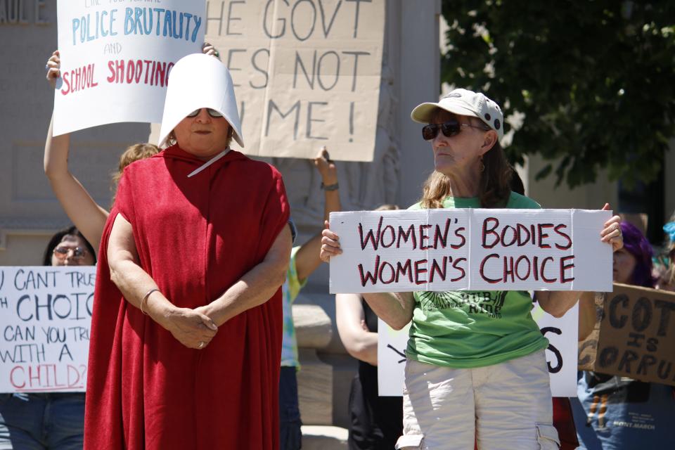 Two protesters stand June 27 at the Monroe County Courthouse after the U.S. Supreme Court repealed Roe vs. Wade on June 24.