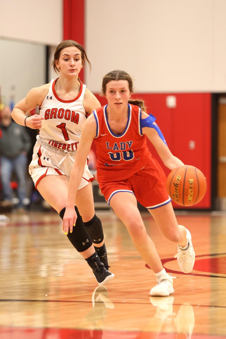 Claude’s Layla Godfrey (00) dribbles the ball in a District 2-1A game against Groom, Tuesday, January 10, 2023, at Groom High School Gym in Groom. Claude won 50-36.