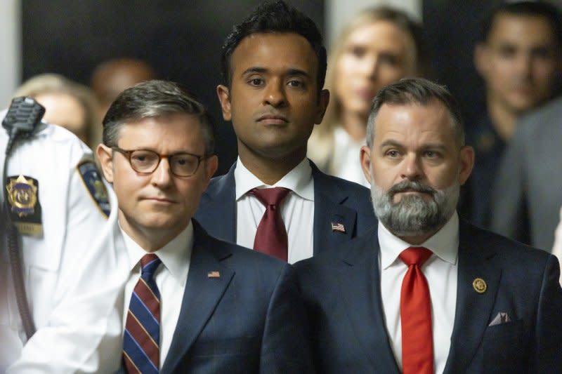 House Speaker Mike Johnson (2-L), businessman and ex-presidential candidate Vivek Ramaswamy (3-L) and U.S. Rep. Cory Mills, R-FL, listen as former US President Donald Trump talks with reporters as he arrives for his Manhattan criminal trial on Tuesday. Pool photo by Justin Lane/UPI