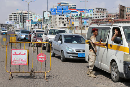 A southern Yemeni separatist fighter checks cars at a checkpoint in the city of Aden, Yemen February 2, 2018. REUTERS/Fawaz Salman