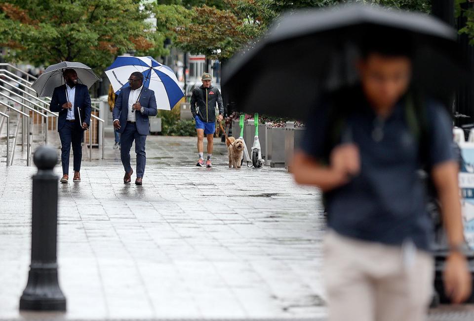 People walk in the rain in downtown Salt Lake City on Tuesday, Aug. 22, 2023. | Kristin Murphy, Deseret News