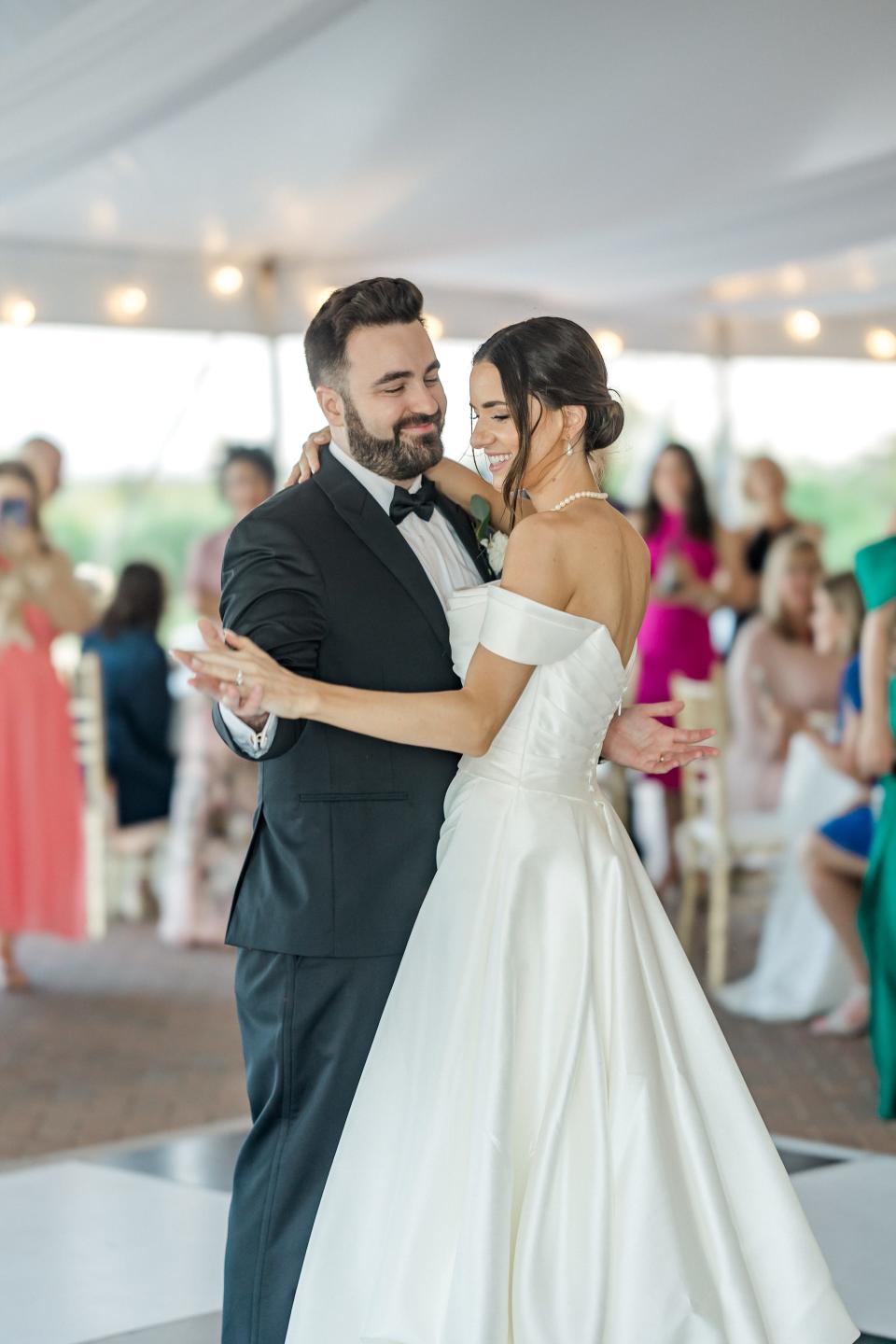 A bride and groom dance during their wedding.