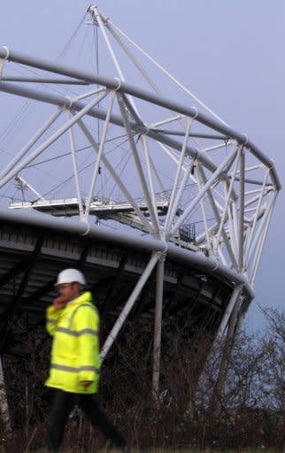 A workman passes the Olympic Stadium in east London. The theme of the London Olympics opening ceremony will be "Isles of Wonder", organisers have revealed, exactly six months before the showpiece extravaganza kicks off the 2012 Games